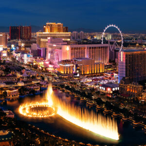 City urban skyline panorama view with modern casino hotel and resort architecture in Strip in Las Vegas at night.